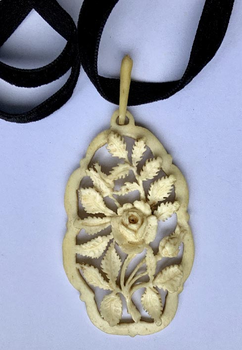 Victorian necklace with carved bone pendant and long velvet ribbon
